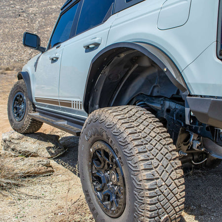 Turn Offroad steel fender flares installed on Ford Bronco, side close-up showing door, fender flare, and wheel on rocky terrain