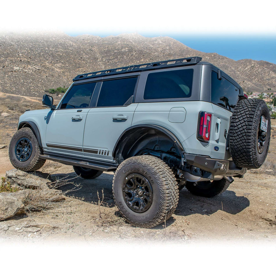 Turn Offroad steel fender flares installed on Ford Bronco, full side profile view with roof rack on rocky terrain