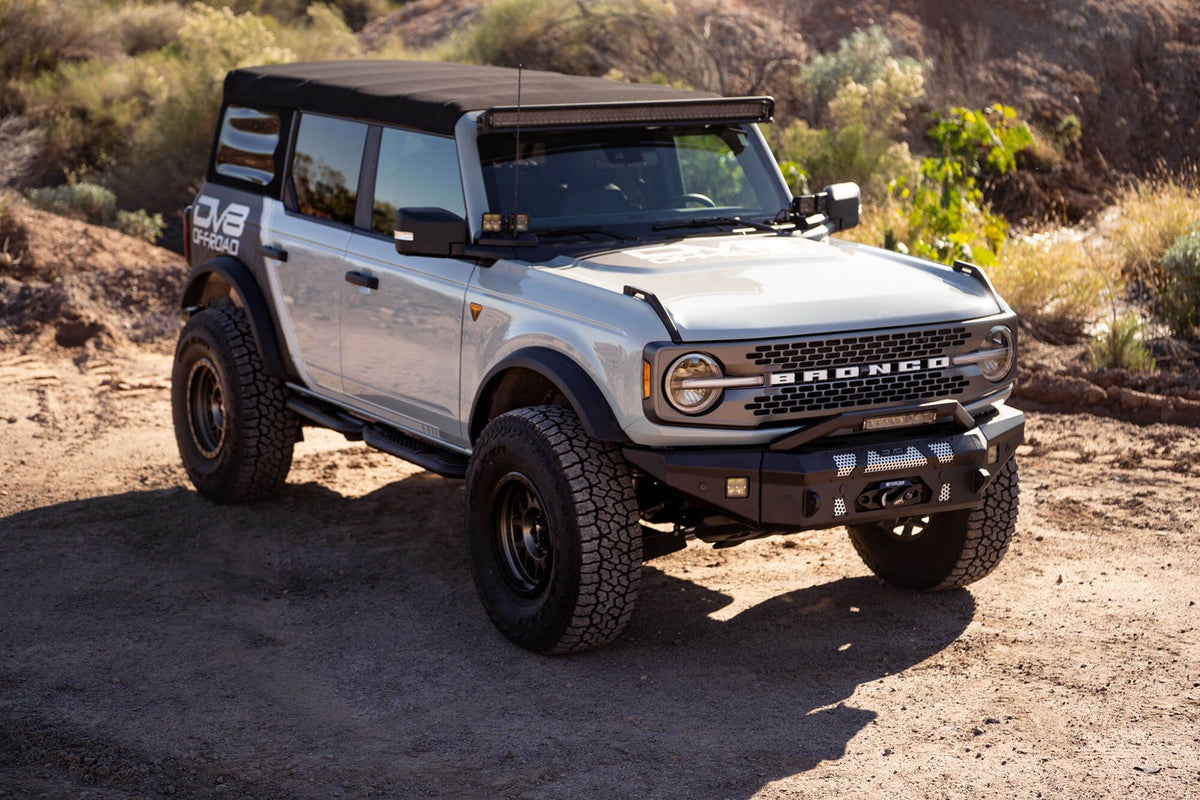 DV8 Offroad 52-inch straight light bar mount installed on 2021-2026 Ford Bronco outdoor wide shot showing complete vehicle setup