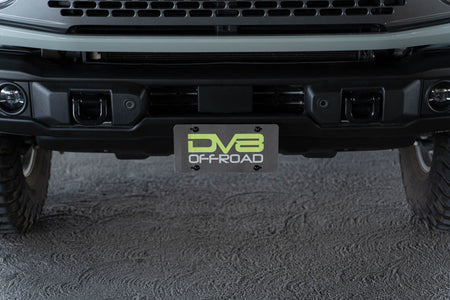 DV8 Offroad license plate mount installed on 2021-2026 Ford Bronco full front view showing complete bumper setup