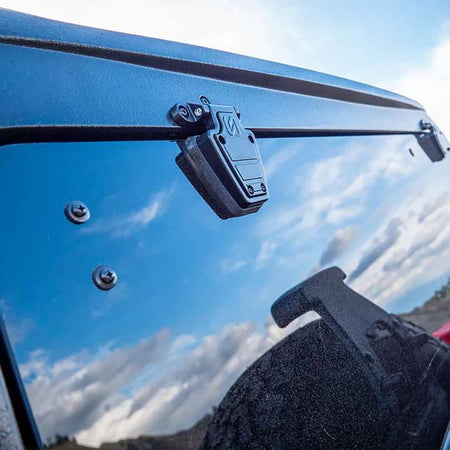 Turn Offroad TR10 hard top close-up showing rear hatch hinge and mounting hardware against sky
