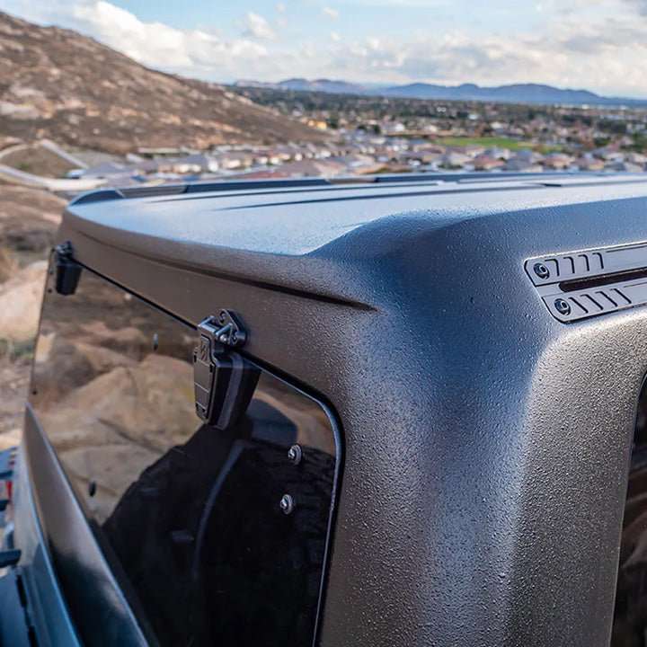 Turn Offroad TR10 hard top close-up showing rear corner and body line over hillside view