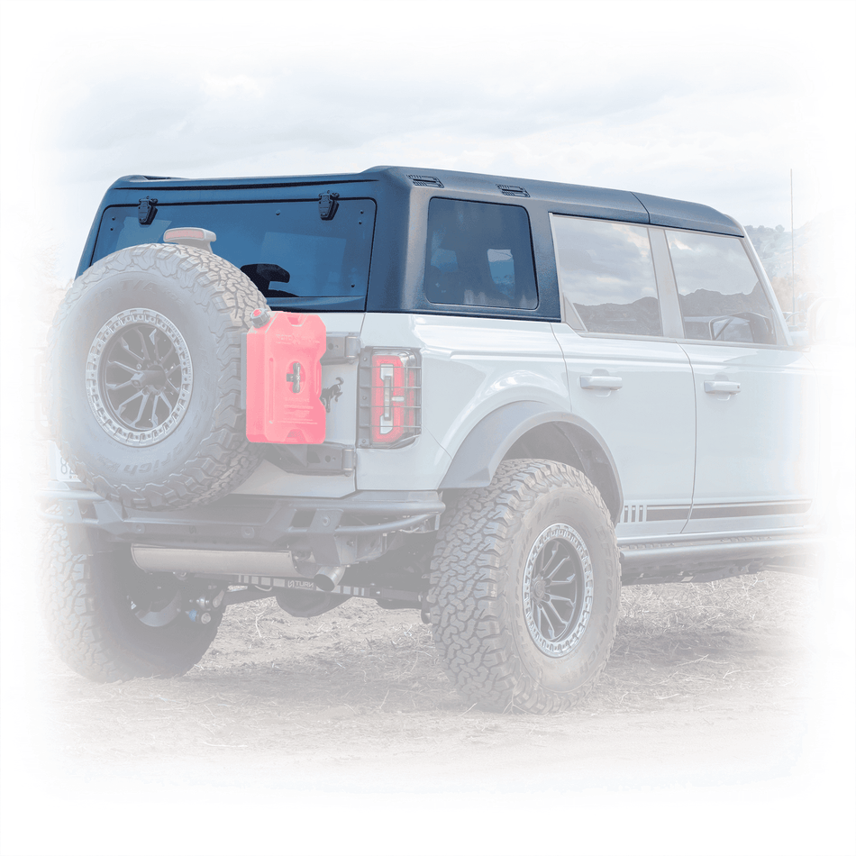 Turn Offroad TR10 hard top installed on white 4-door Ford Bronco, close-up rear three-quarter view showing spare tire and fuel canister