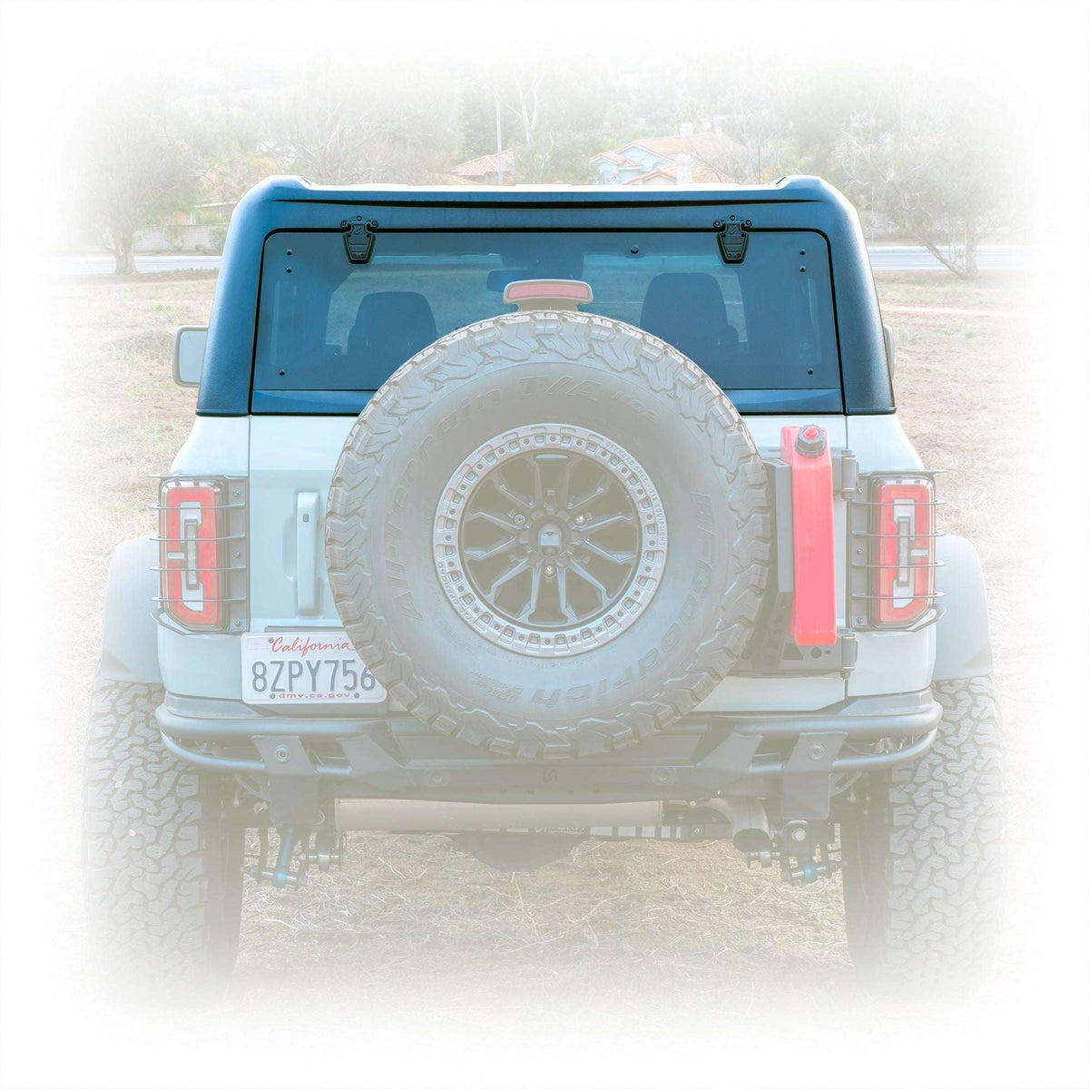 Turn Offroad TR10 hard top installed on white 4-door Ford Bronco, rear view showing spare tire and taillights