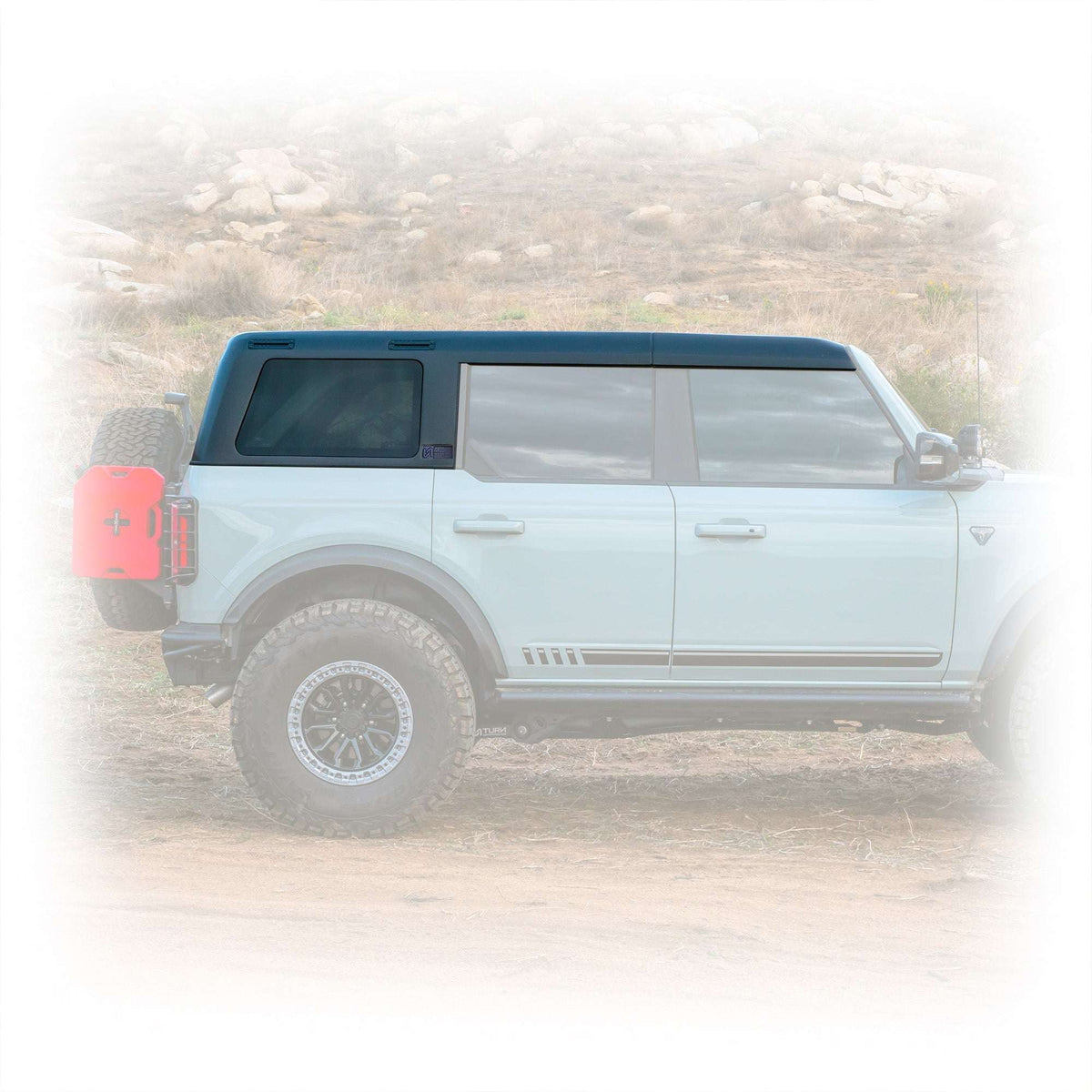 Turn Offroad TR10 hard top installed on gray 4-door Ford Bronco, side profile view on dirt trail
