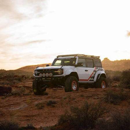 DV8 Offroad Tube Series front bumper installed on Ford Bronco Raptor – three-quarter rear view desert