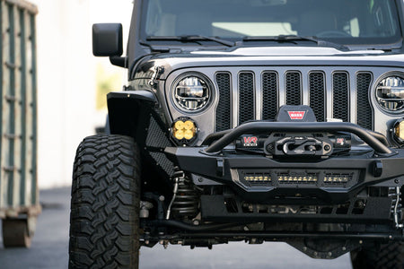 Front view of a Jeep with off-road accessories on a blurred background