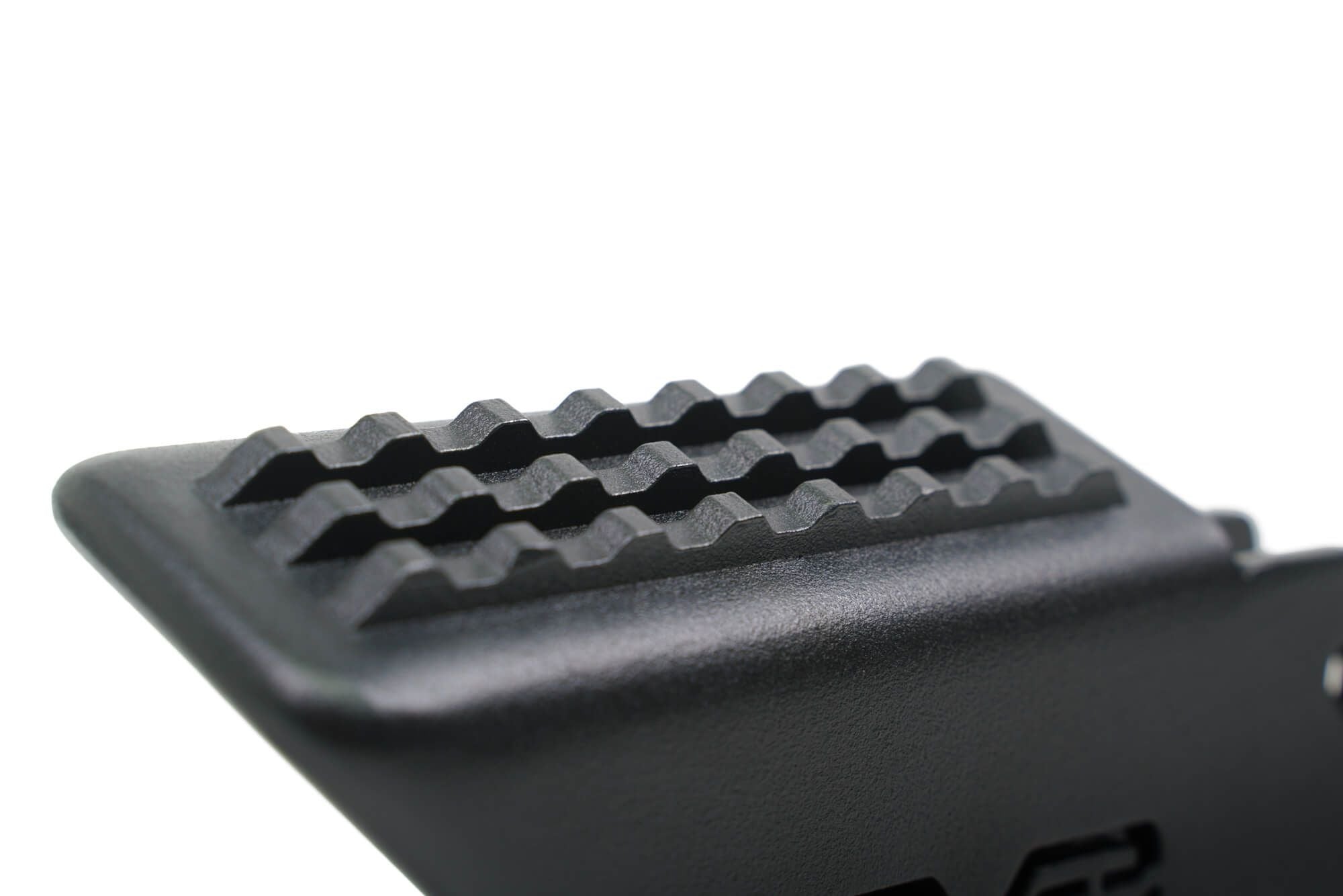 DV8 Offroad foot peg close-up top view showing full grip surface texture detail