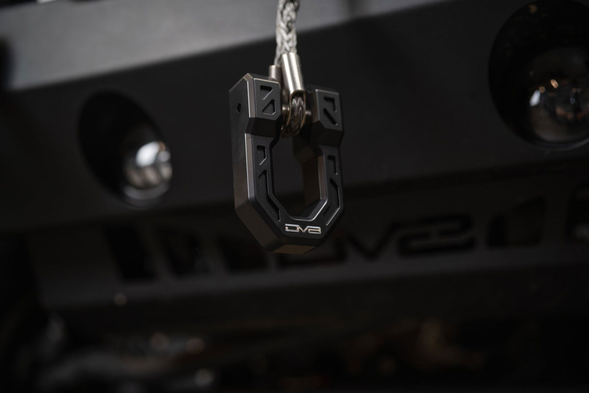 DV8 Offroad Xtract fairlead installed on bumper, low-light close-up with keys hanging from nearby hook